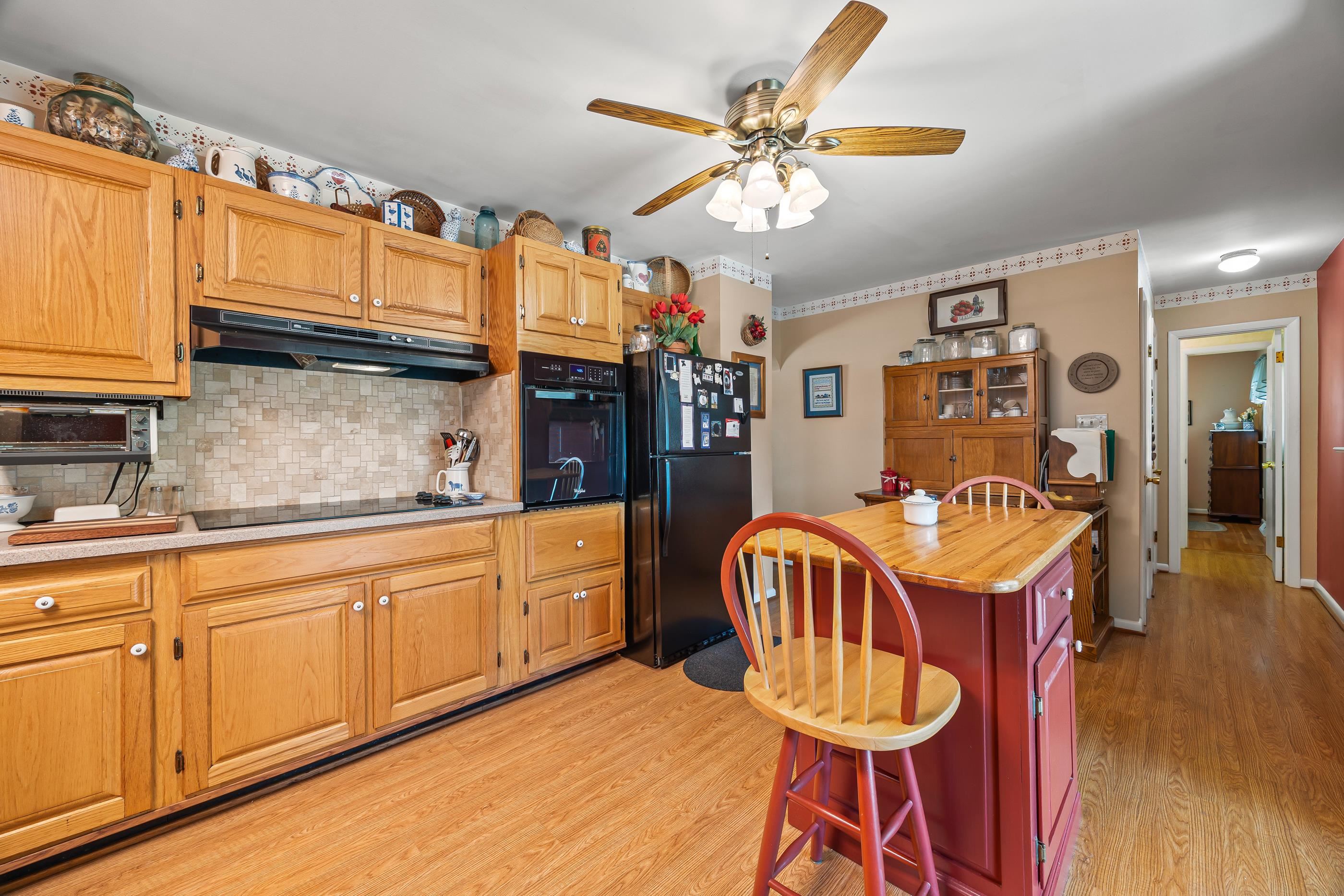 208 Tuxedo Road Staunton, VA 24401 - Photo 13 of 46 a kitchen with granite countertop a dining table chairs and white cabinets