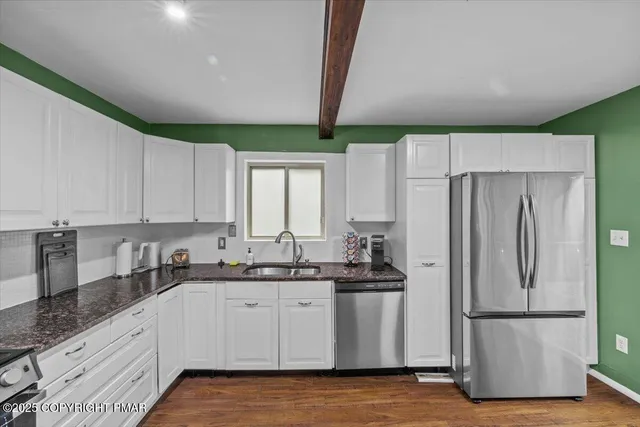 a kitchen with stainless steel appliances a refrigerator sink and cabinets