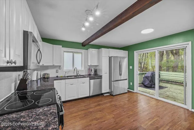 a kitchen with refrigerator and cabinets