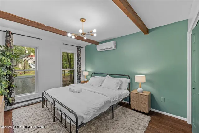 a bedroom with a large bed and a chandelier