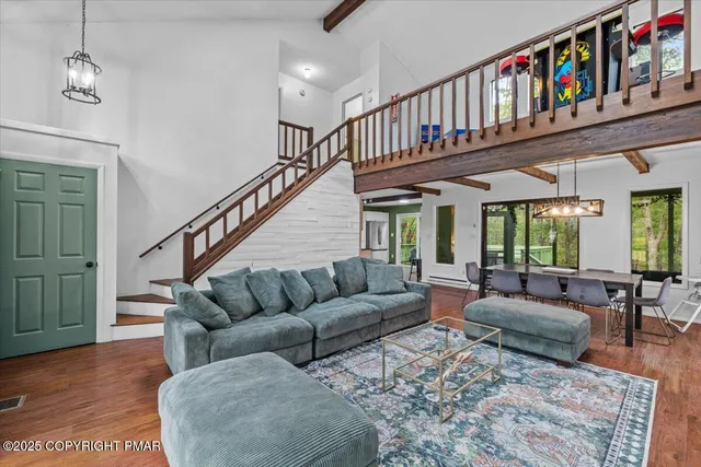 a living room with furniture ceiling fan and a book shelf