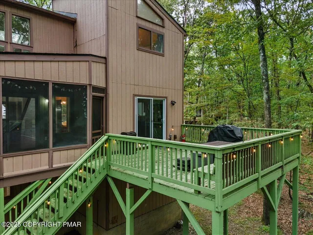 a view of a house with a yard and trees