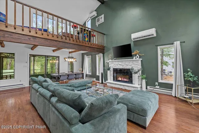 a living room with furniture a flat screen tv and a fireplace