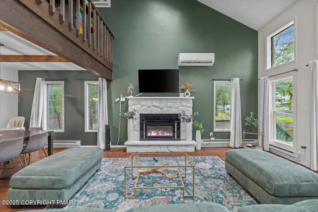 a living room with furniture and a fireplace