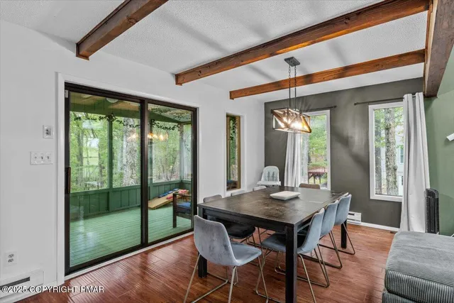 a view of a dining room with furniture window and wooden floor