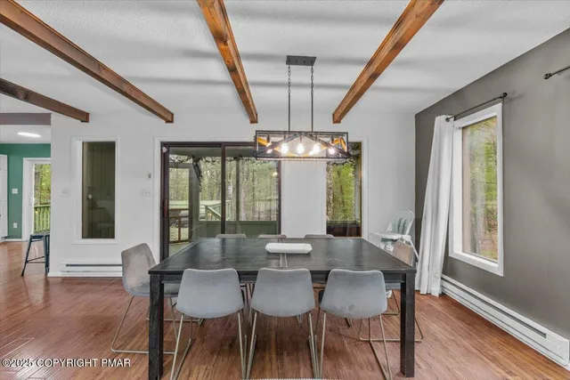 a view of a dining room with furniture and window
