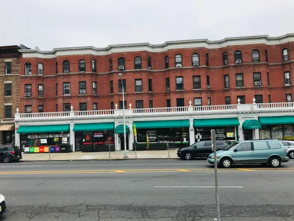 a front view of building with cars parked