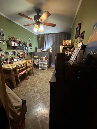 a room with gym equipment and a chandelier