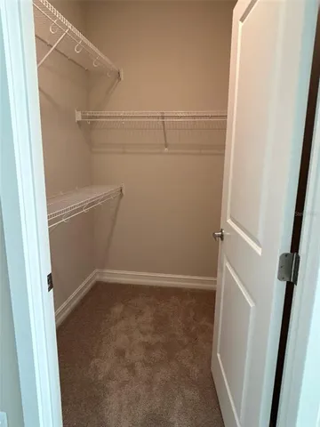 a bathroom with a granite countertop toilet sink and mirror
