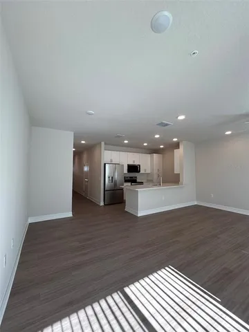 a view of kitchen and hall with wooden floor