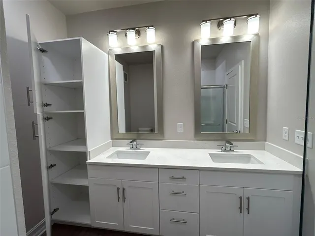 a bathroom with a glass shower door