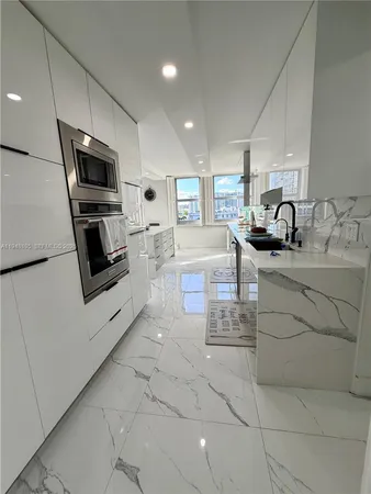 a kitchen with a sink stainless steel appliances and cabinets