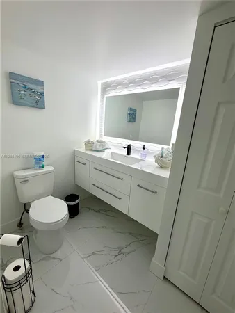 a bathroom with a toilet sink and mirror