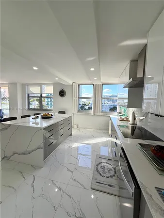 a large kitchen with stainless steel appliances lots of counter top space and cabinets