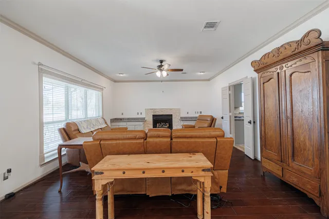 a kitchen with stainless steel appliances granite countertop a stove top oven a sink dishwasher a dining table and chairs with wooden floor