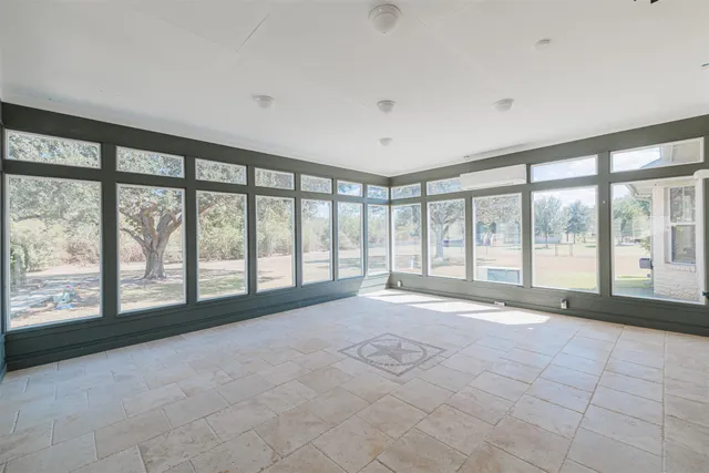 a living room with furniture a fireplace and a large window