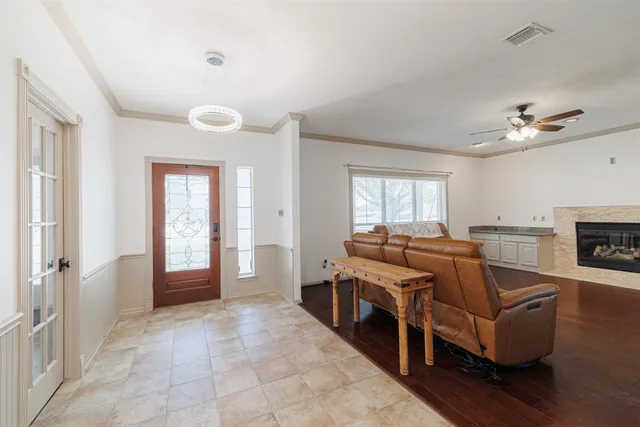a living room with furniture a fireplace and wooden floor