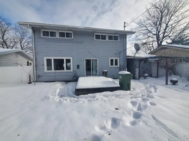 a view of a house with a yard and sitting area