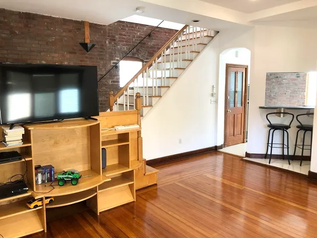 a view of an entryway with wooden floor