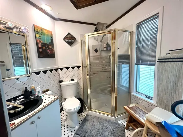 a bathroom with a toilet sink and shower
