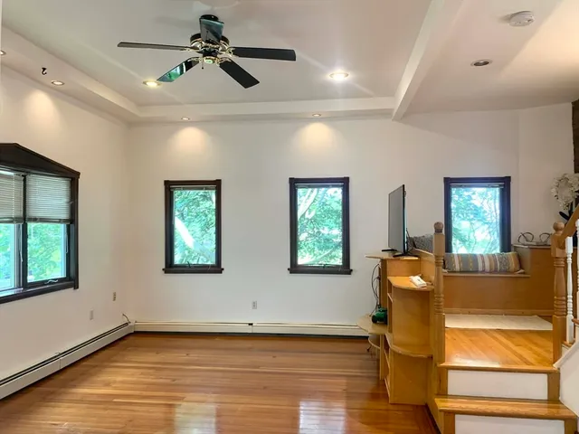 a view of a livingroom with a window and wooden floor