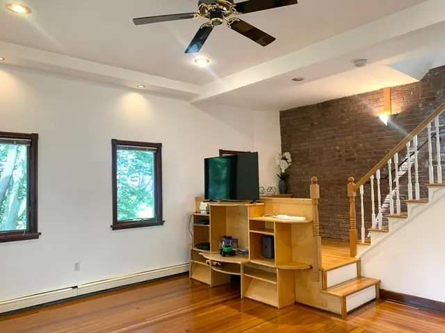 a view of a livingroom with furniture and a ceiling fan