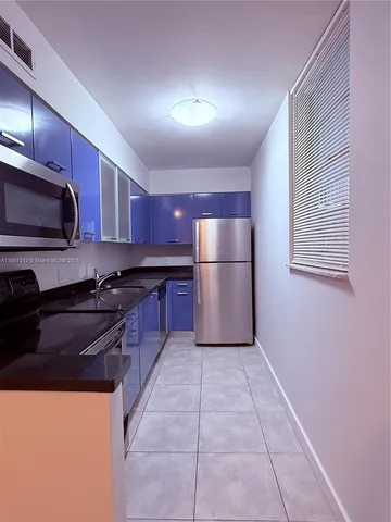 a large kitchen with cabinets and stainless steel appliances