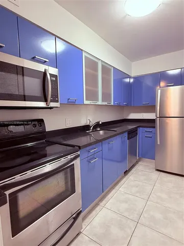 a kitchen with a stove microwave and refrigerator