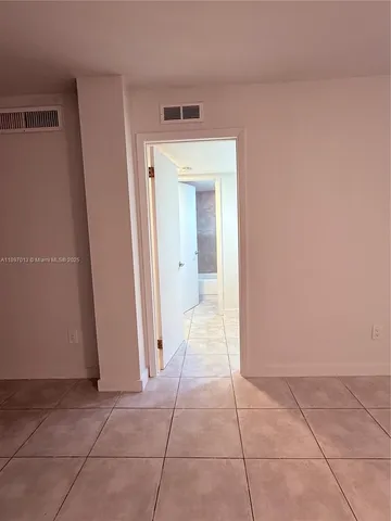 a view of a hallway to rooms