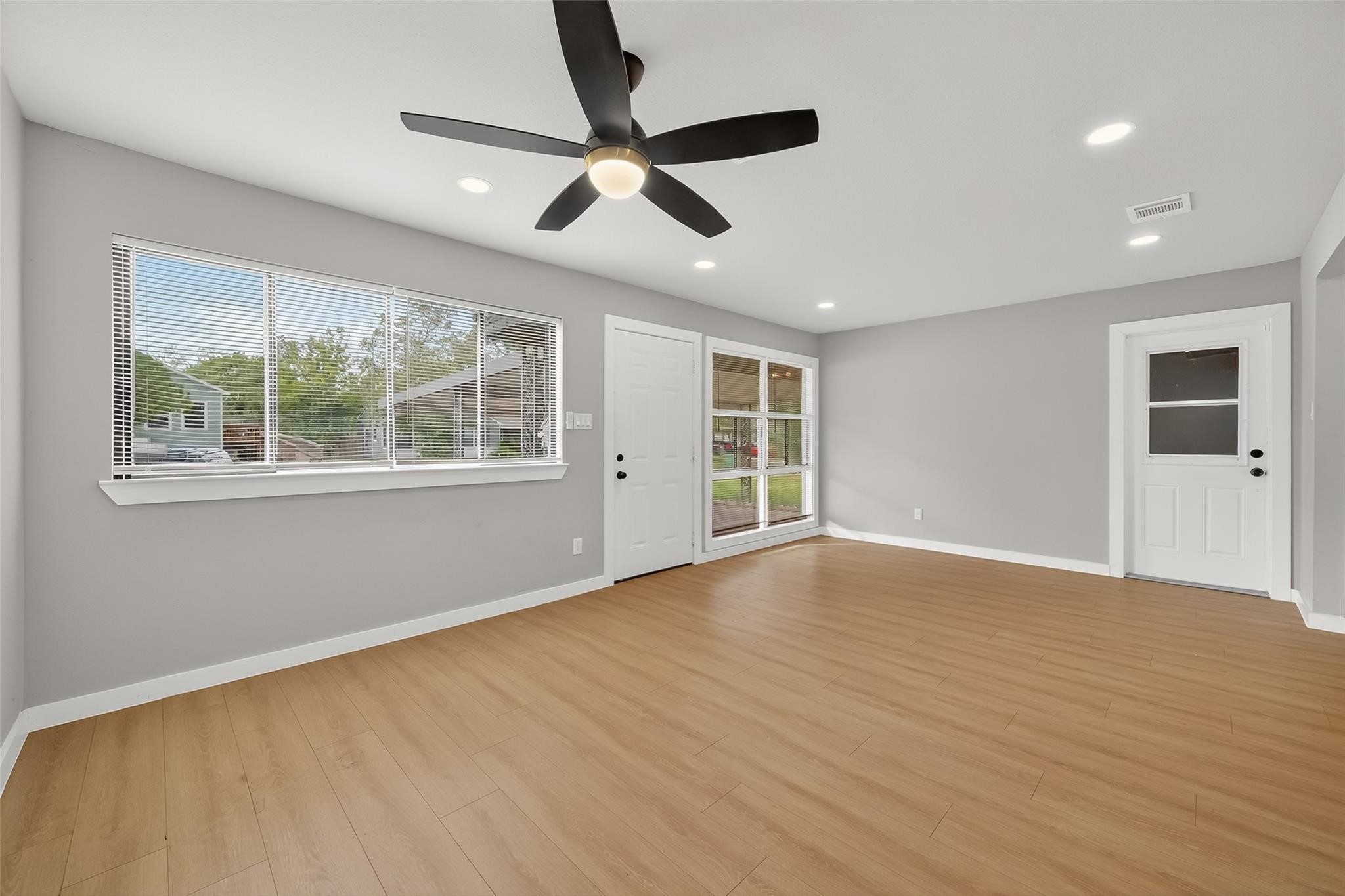 4403 Botany Lane Houston, TX 77047 - Photo 3 of 14 a view of an empty room with wooden floor and a window