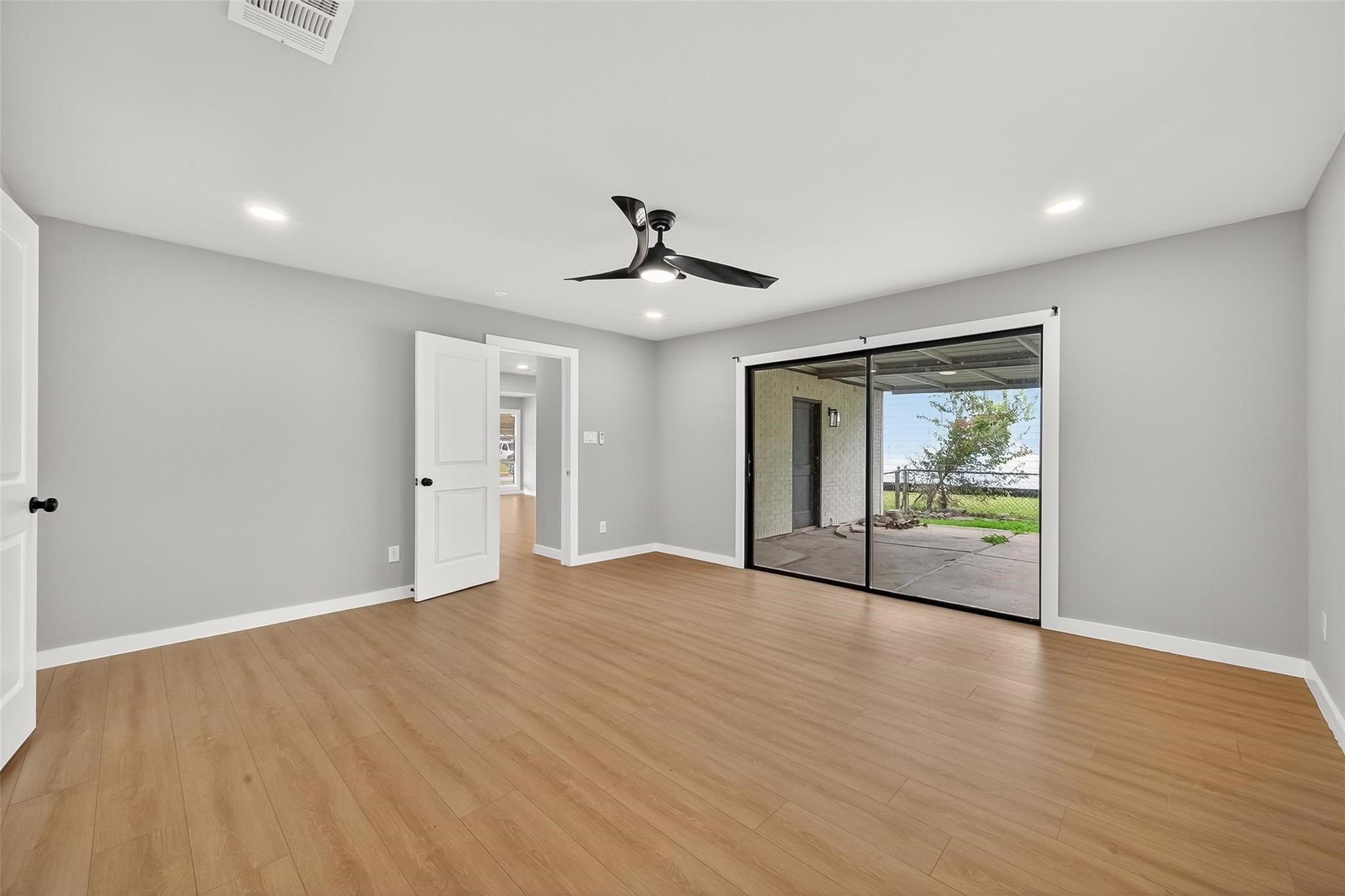 4403 Botany Lane Houston, TX 77047 - Photo 4 of 14 a view of an empty room with wooden floor and a window