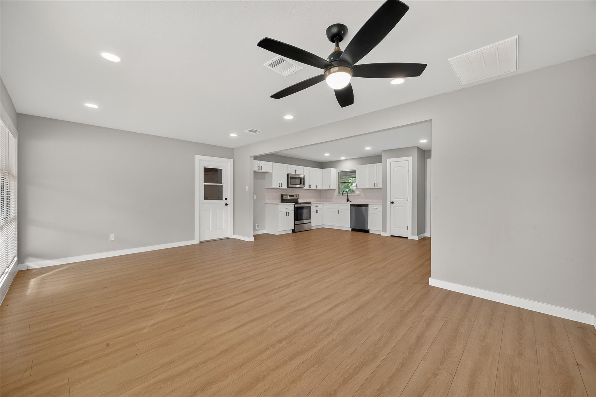 4403 Botany Lane Houston, TX 77047 - Photo 7 of 14 a view of empty room with wooden floor and window