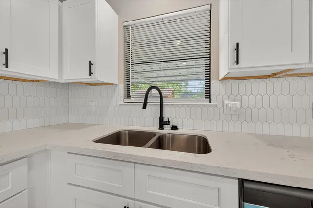 a kitchen with a sink and cabinets