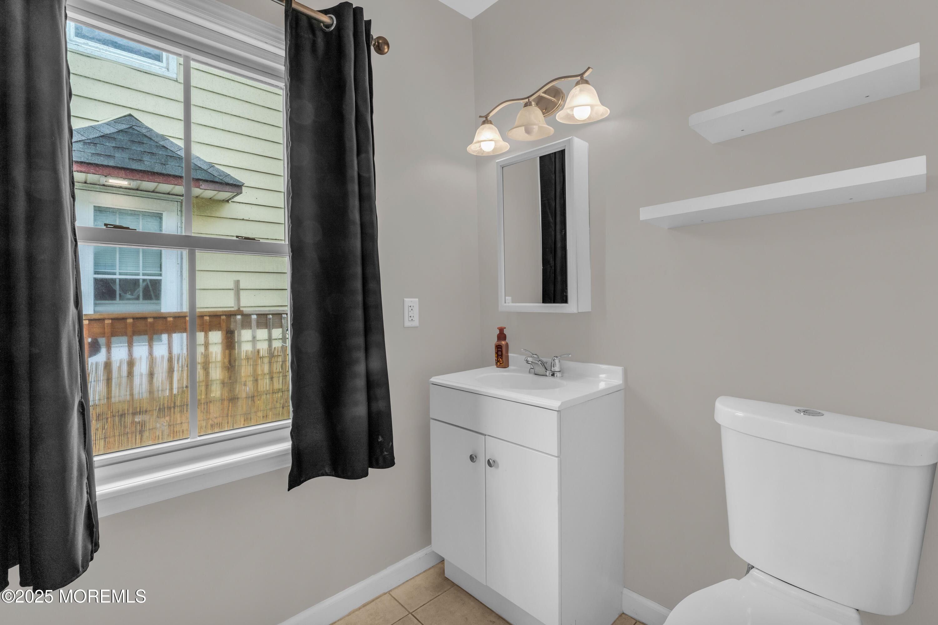 51 Matthew Street Highlands, NJ 07732 - Photo 12 of 19 a bathroom with a toilet sink and mirror