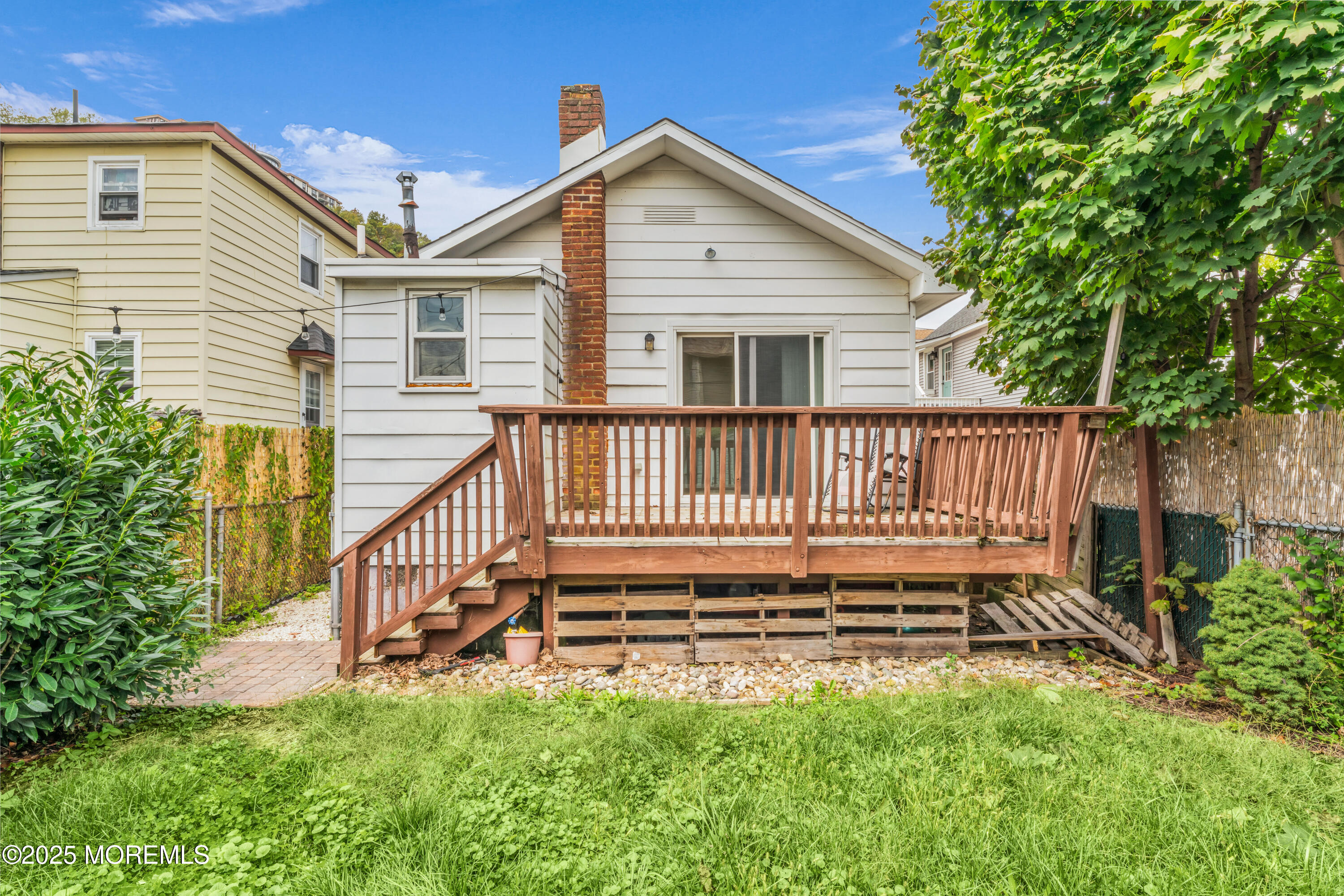 51 Matthew Street Highlands, NJ 07732 - Photo 16 of 19 a view of a house with a small yard and wooden fence