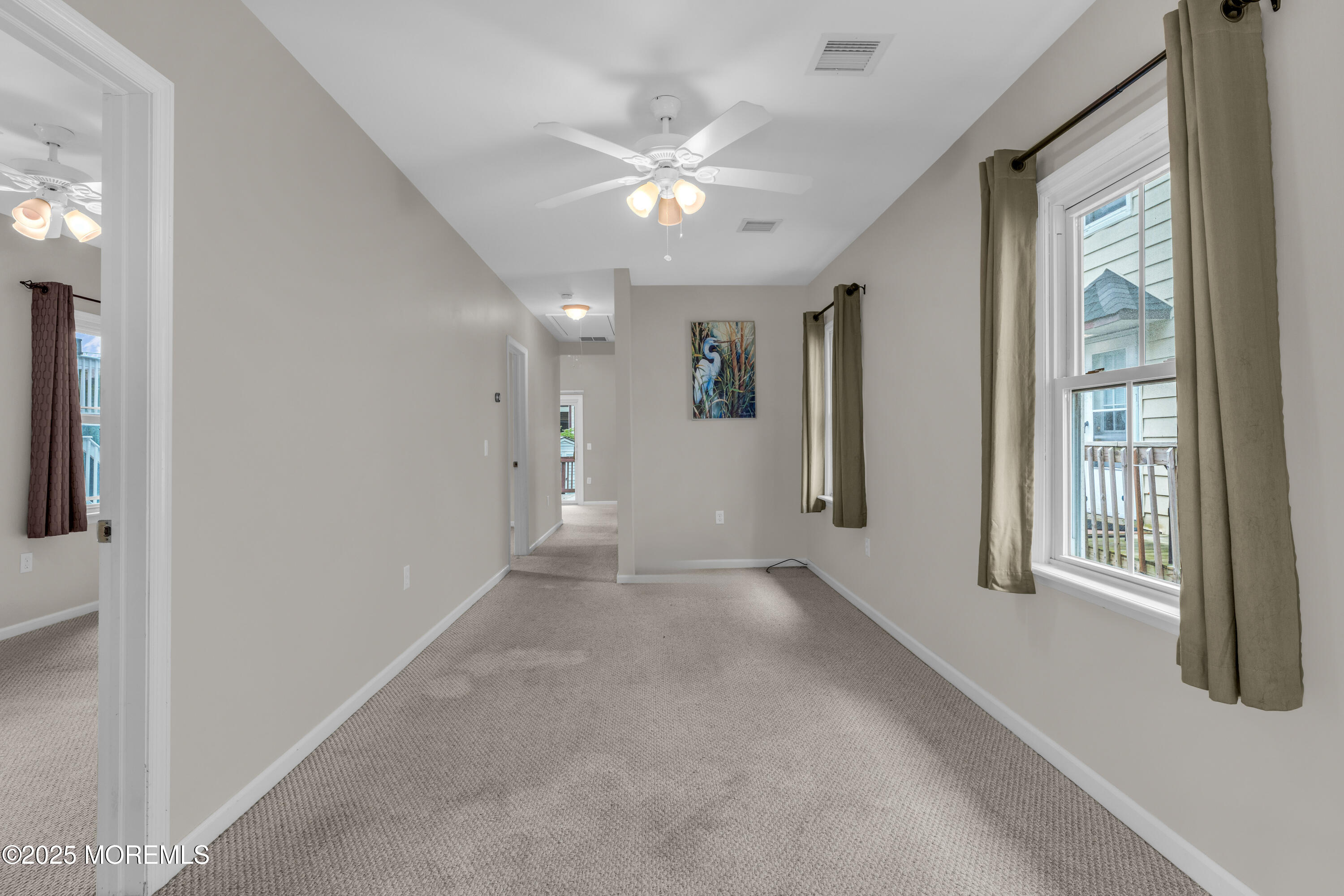 51 Matthew Street Highlands, NJ 07732 - Photo 6 of 19 en empty room with windows and ceiling fan