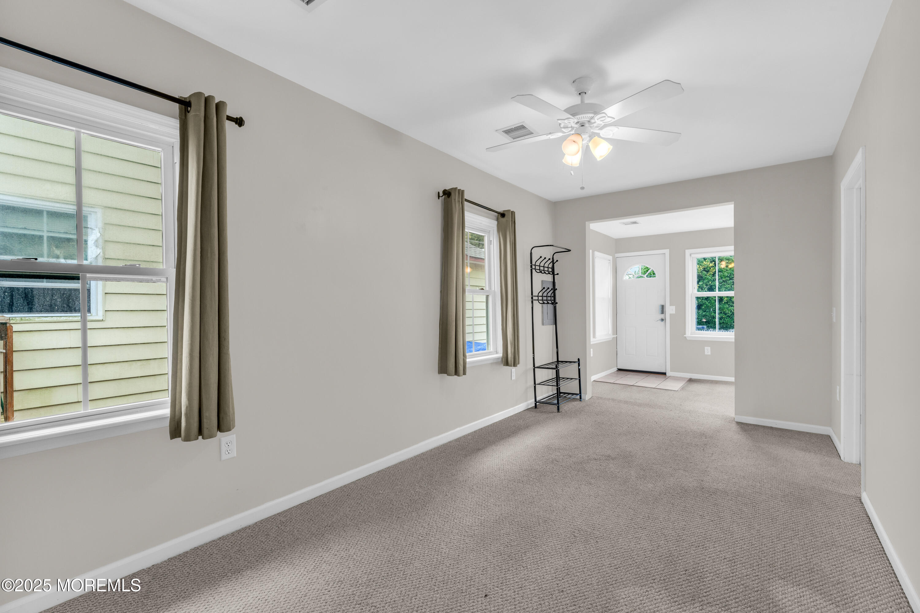 51 Matthew Street Highlands, NJ 07732 - Photo 7 of 19 an empty room with windows and ceiling fan