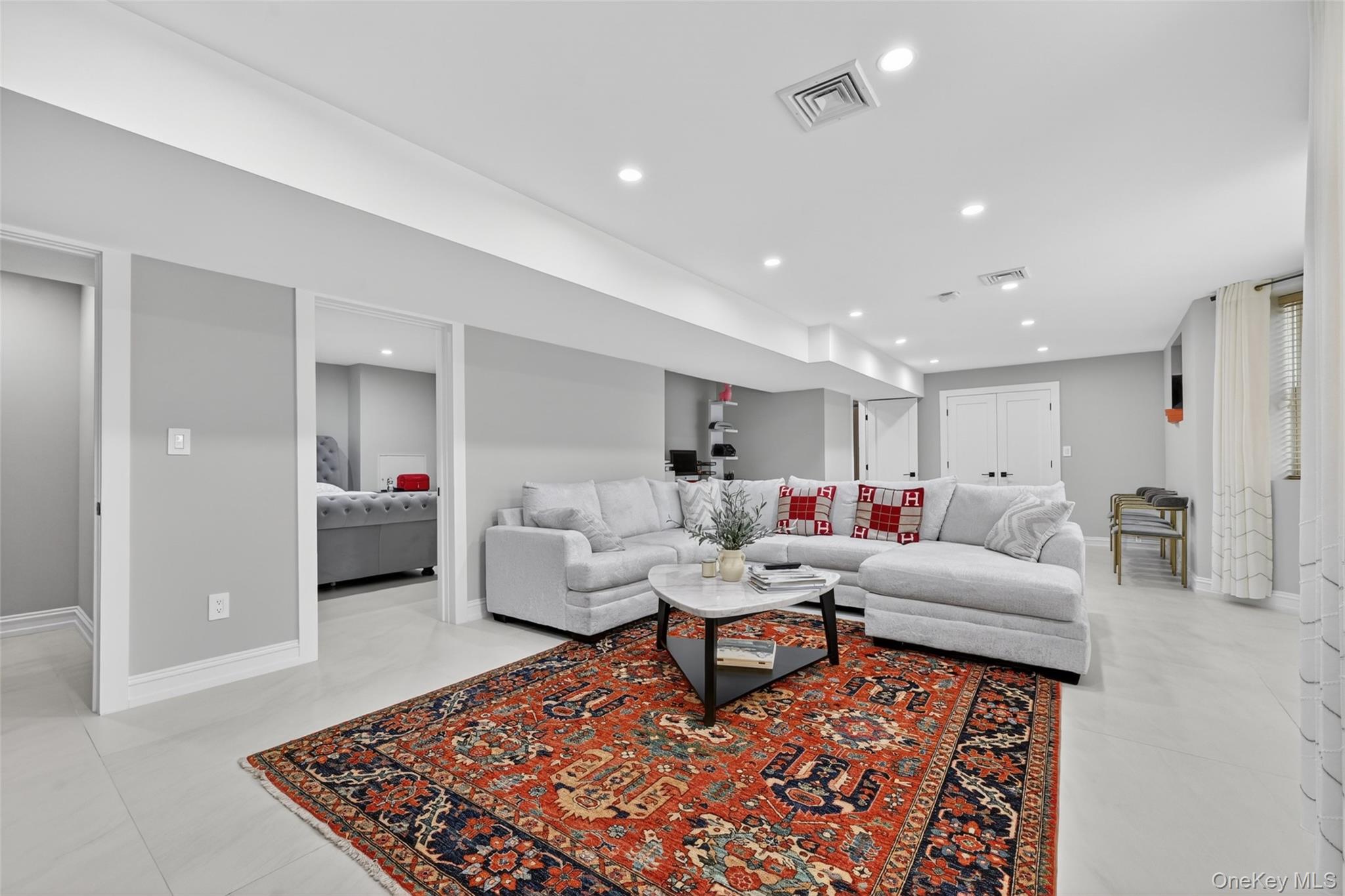 65 Wildway Bronxville, NY 10708 - Photo 27 of 42 Spacious living area featuring light gray walls, recessed lighting, and large format light-toned tile flooring