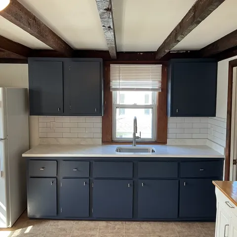 a kitchen with a sink a cabinets and window