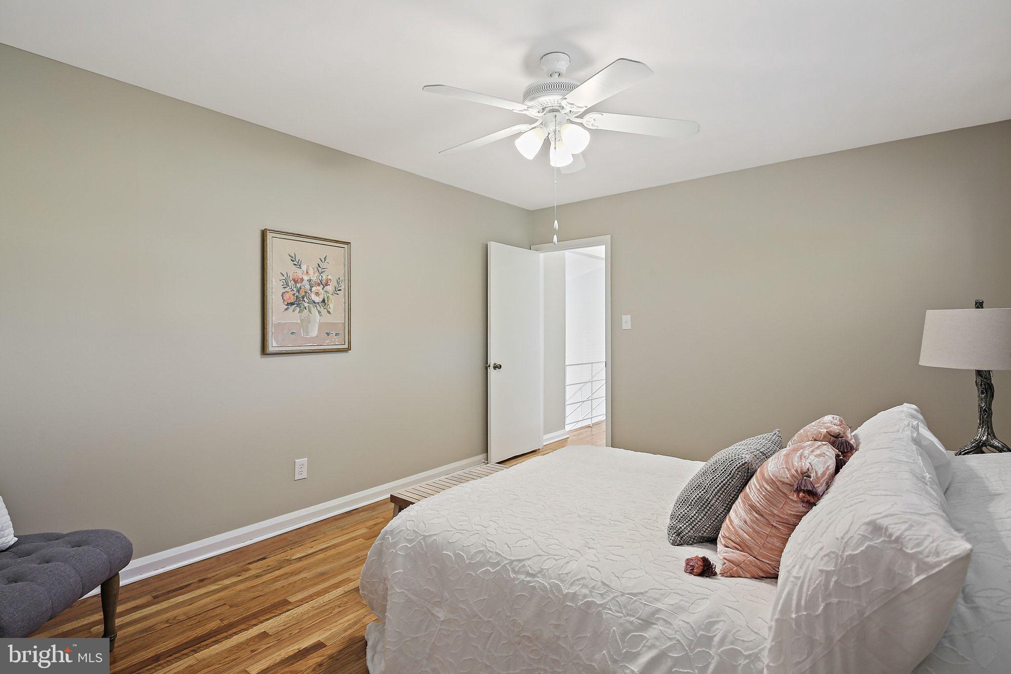6204 Scranton Road Baltimore, MD 21237 - Photo 14 of 31 a bedroom with a bed and a chandelier
