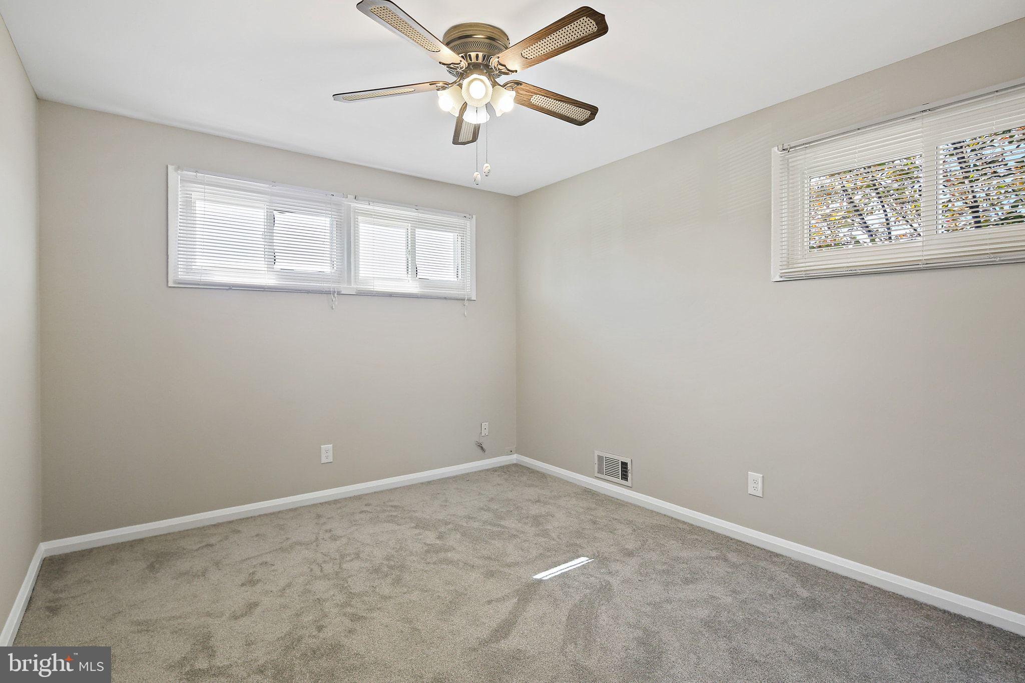 6204 Scranton Road Baltimore, MD 21237 - Photo 15 of 31 an empty room with windows and fan
