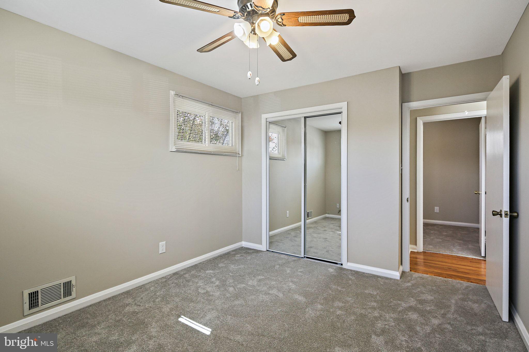 6204 Scranton Road Baltimore, MD 21237 - Photo 16 of 31 an empty room with closet and a chandelier fan