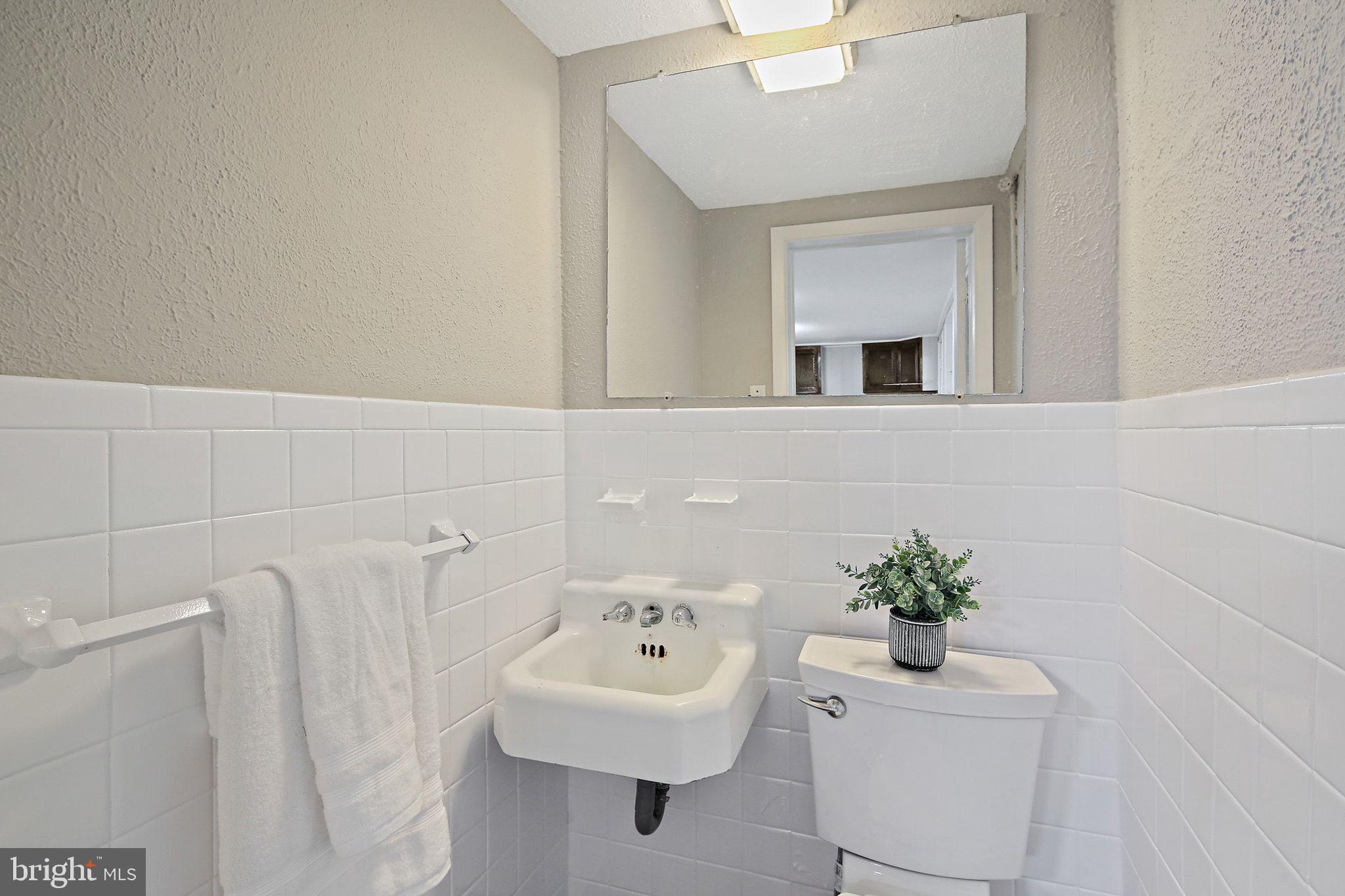 6204 Scranton Road Baltimore, MD 21237 - Photo 23 of 31 a bathroom with a sink a mirror and vanity