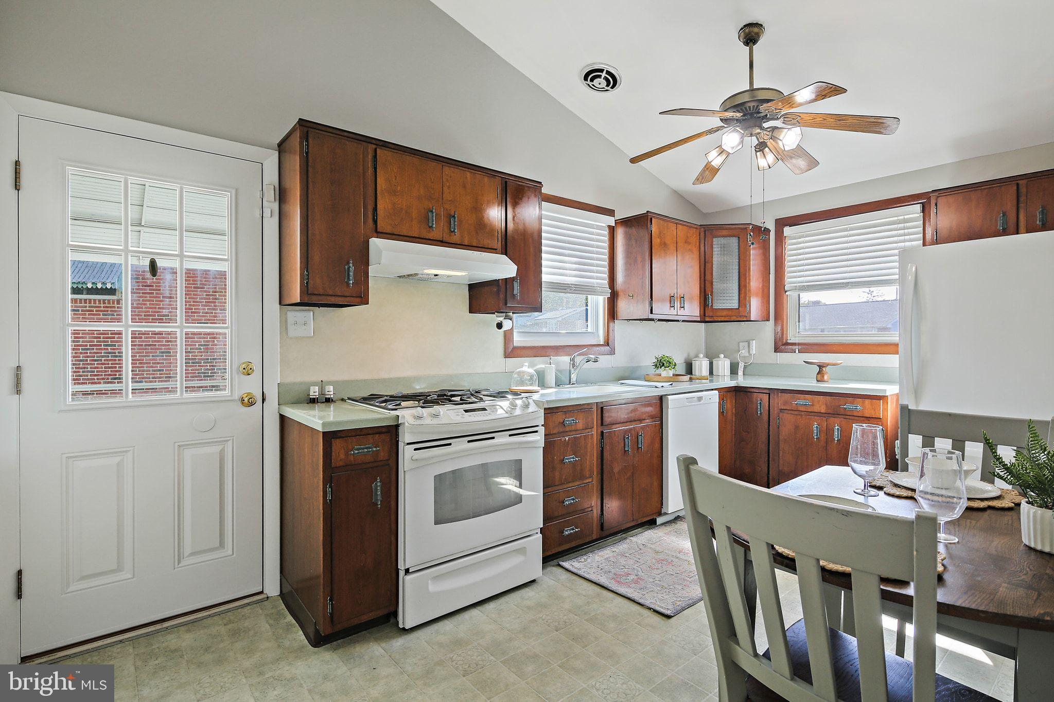 6204 Scranton Road Baltimore, MD 21237 - Photo 8 of 31 a kitchen with stainless steel appliances granite countertop a stove a sink dishwasher and a refrigerator