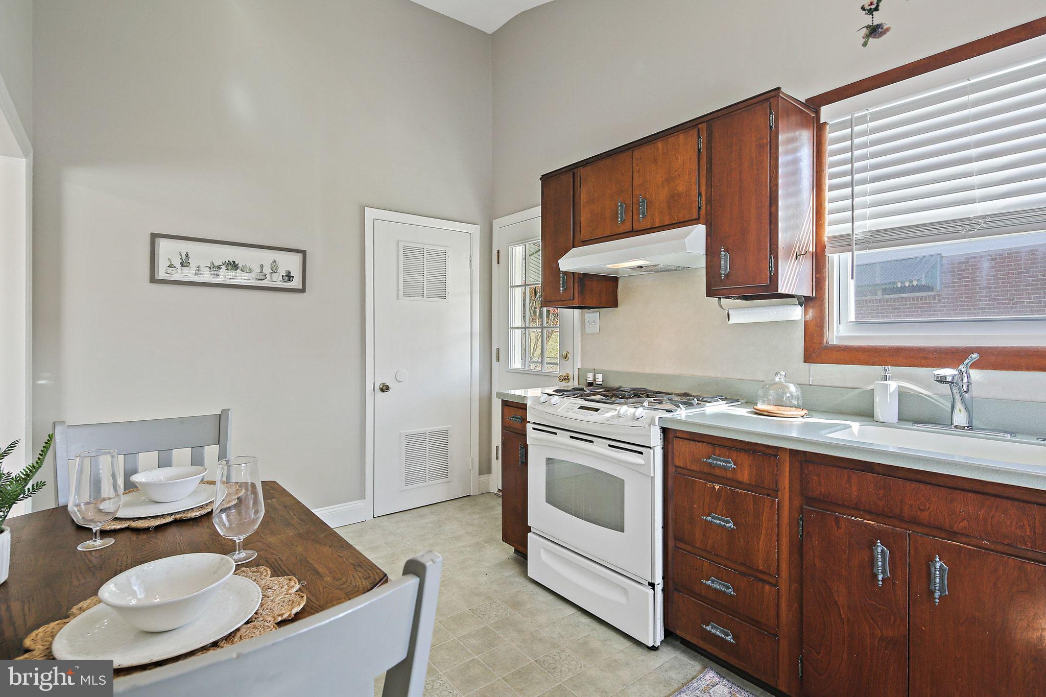 6204 Scranton Road Baltimore, MD 21237 - Photo 9 of 31 a kitchen with stainless steel appliances granite countertop a sink stove and cabinets