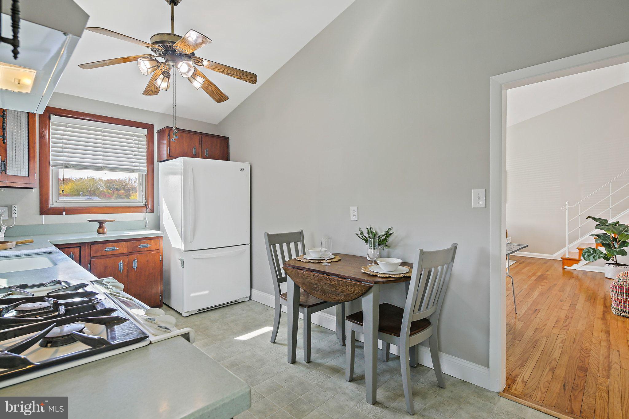 6204 Scranton Road Baltimore, MD 21237 - Photo 10 of 31 a dining room with furniture and a chandelier