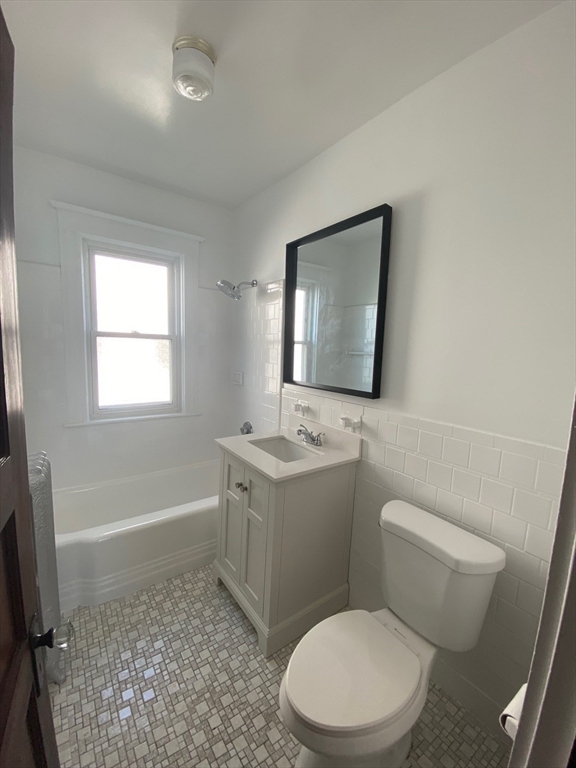 14 Welton Road Boston, MA 02132 - Photo 17 of 31 a bathroom with a sink a toilet and mirror