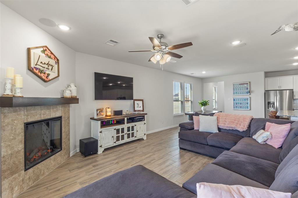 551 Ruthye Lane Pilot Point, TX 76258 - Photo 14 of 40 a living room with furniture a fireplace and a flat screen tv
