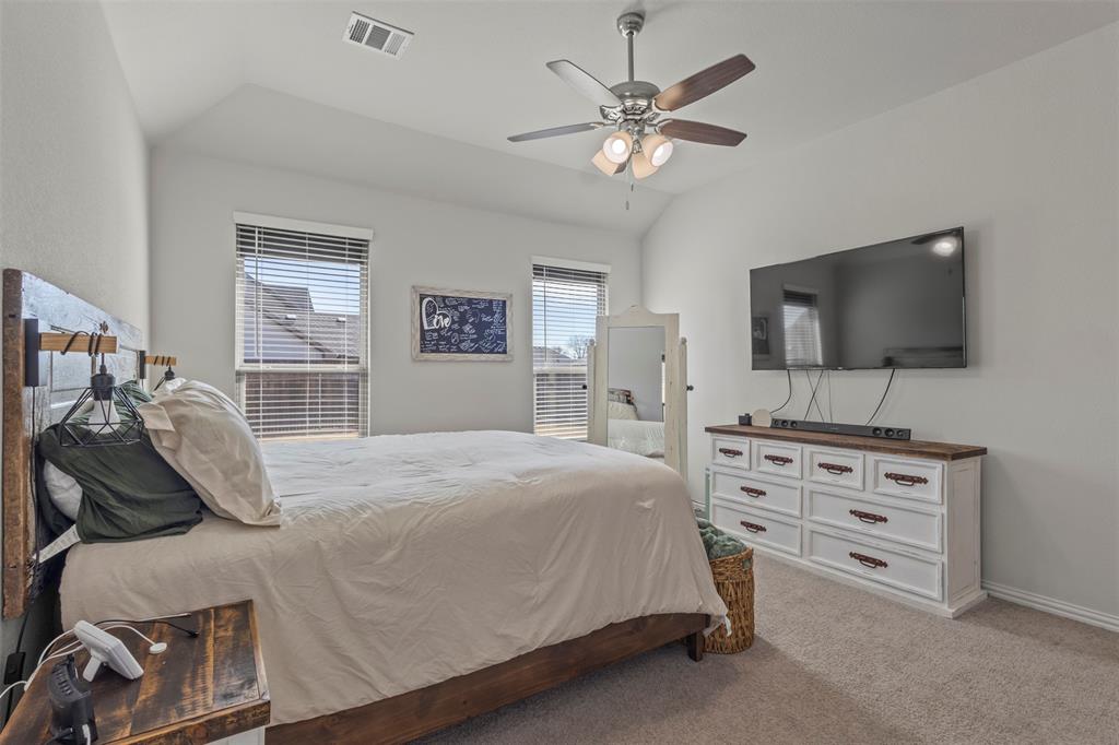 551 Ruthye Lane Pilot Point, TX 76258 - Photo 17 of 40 a bedroom with a bed and a flat screen tv