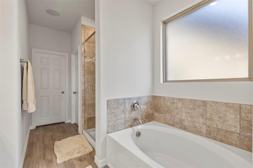 551 Ruthye Lane Pilot Point, TX 76258 - Photo 18 of 40 a bathroom with a bathtub and a shower